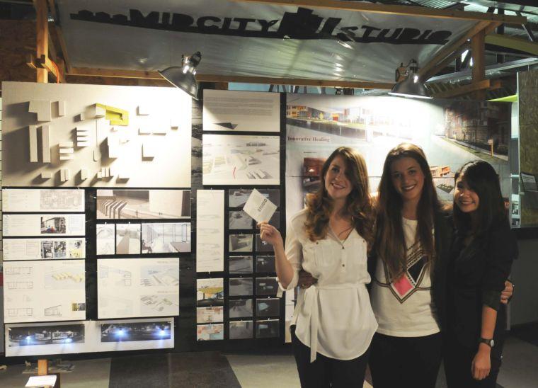 Architecture seniors Eva Rodriguez, Jeanette Fein, and Christine Nguyen stand in front of their project proposal during White Light Night at Letterman&#8217;s Blue Print and Supply on 4627 Government Street.