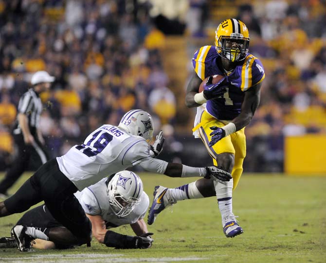 LSU senior running back Alfred Blue (4) evades Furman defenders Saturday, Oct. 26, 2013 during the Tigers' 48+16 win against the Paladins in Tiger Stadium.