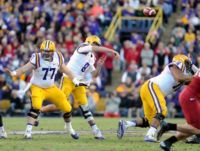 LSU senior quarterback Zach Mettenberger (8) throws the football to a receiver Friday, Nov. 29, 2013 during the Tigers' 31-27 victory against Arkansas in Tiger Stadium.