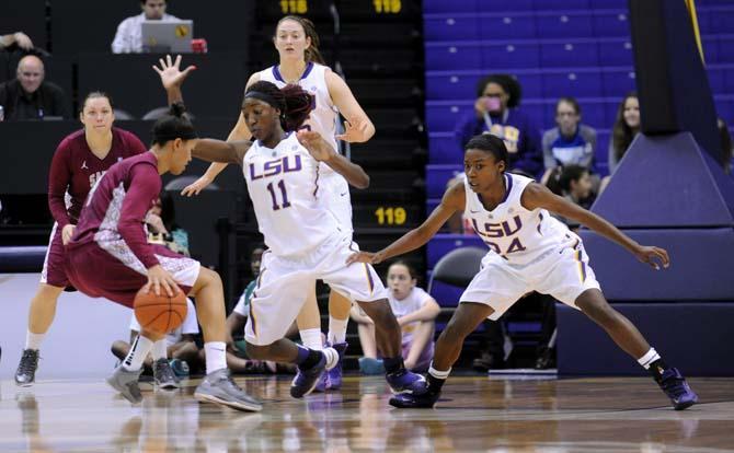 LSU freshman guard Raigyne Moncrief (11) and junior guard DaShawn Harden (24) attempt to make a block Sunday, Nov. 10, 2013 during the Tigers' 80-64 victory against St. Joseph's University in the PMAC.