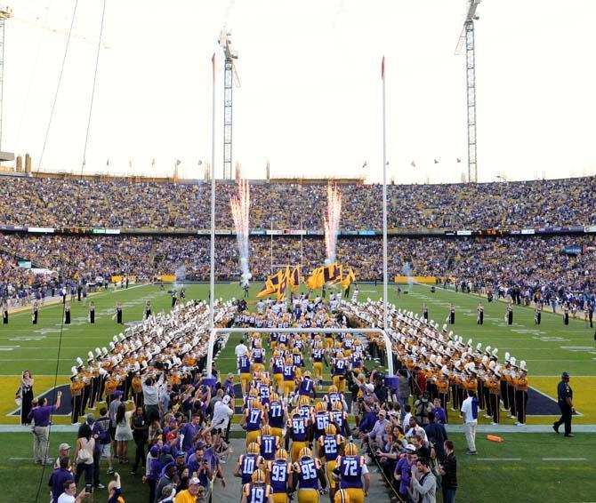 The LSU football team runs onto the field Saturday, Oct. 26, 2013 before the Tigers' 48-16 win against Furman in Tiger Stadium.