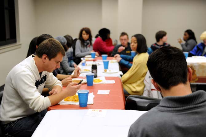 Students sit around some tables and enjoy an early thanksgiving feast on Tuesday, Nov. 26, 2013, as a part of Spectrum's fall feast in the Women's Center.