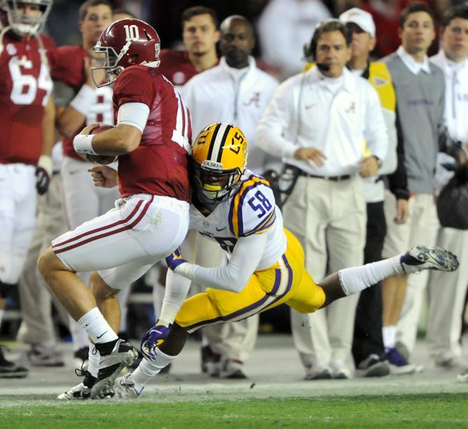 LSU senior linebacker Tahj Jones (58) commits a personal foul on Alabama senior quarterback AJ McCarron on Saturday, Nov. 9, 2013 during the Tiger's 38-17 loss to the Alabama Crimson Tide at Bryant-Denny Stadium in Tuscaloosa, AL.