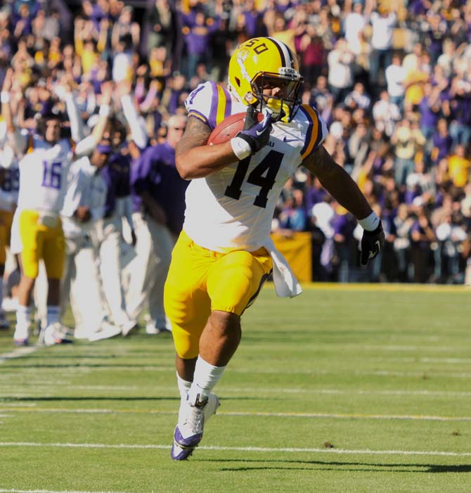 LSU junior running back Terrence Magee (14) runs toward the endzone Friday, Nov. 29, 2013 during the Tigers' 31-27 victory against Arkansas.