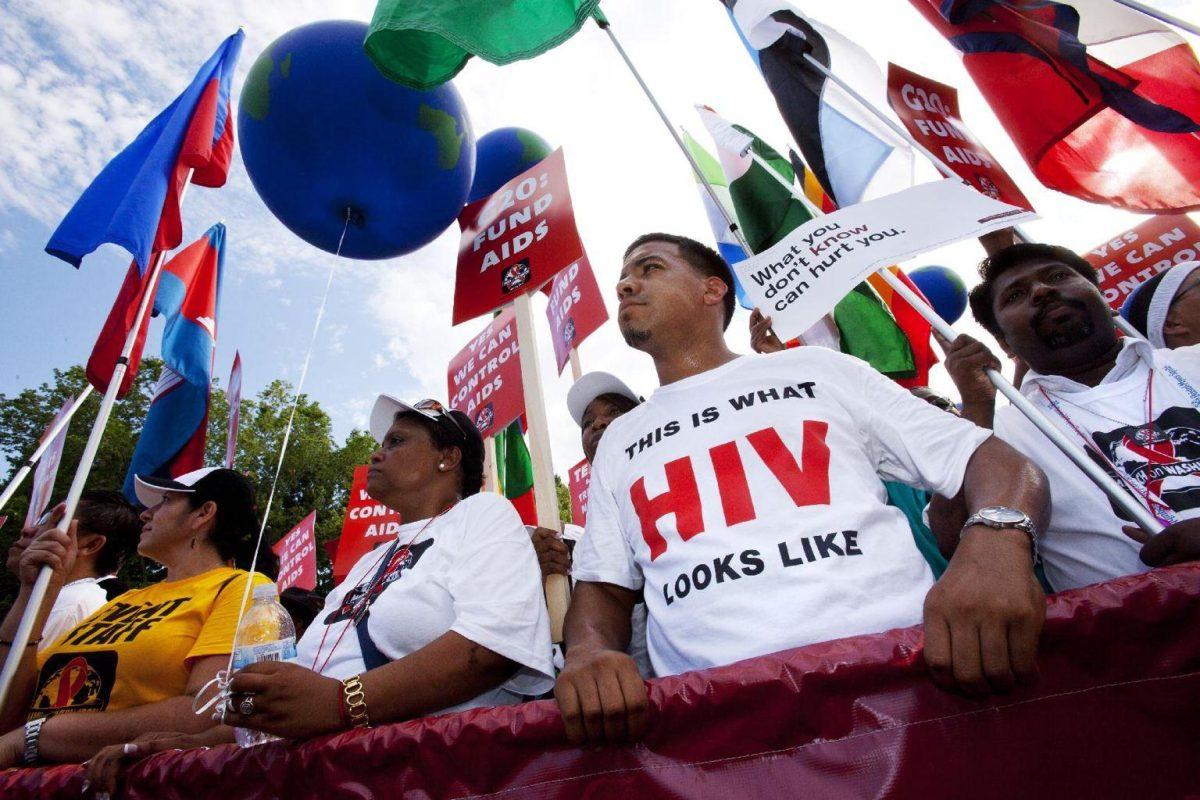 Marco Benjamin, 32, of New Brunswick, N.J., second from right, who is HIV positive, walks in the AIDS March in Washington, Sunday, July 22, 2012. (AP Photo/Jacquelyn Martin)