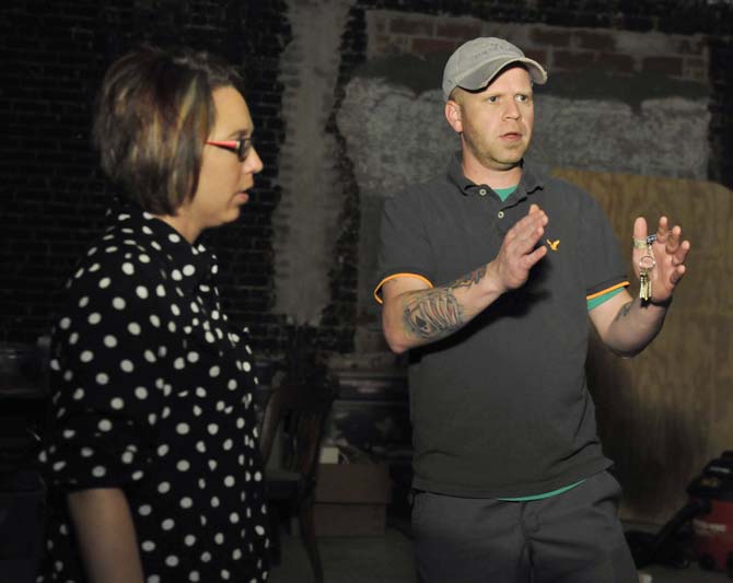 Owners Chris and Sommer Wadsworth talk about their plans for their business on Tuesday, November 5, 2013 in the darkness of the room that is intended to be the kitchen for Triumph Kitchen. The room that they're turning into a huge training kitchen has never been developed before and has been left in darkness and desolution for over 100 years.