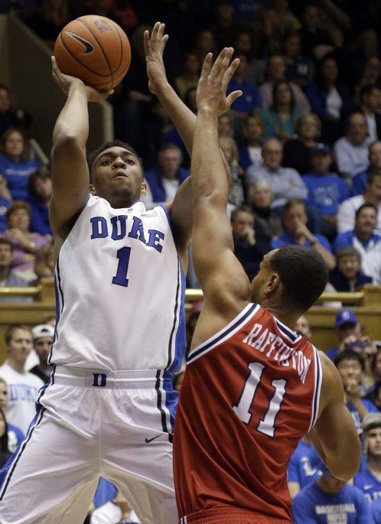 Duke's Jabari Parker (1) shoots as Florida Atlantic's Justin Raffington (11) defends during the second half of an NCAA college basketball game in Durham, N.C., Friday, Nov. 15, 2013. Duke won 97-64. (AP Photo/Gerry Broome)