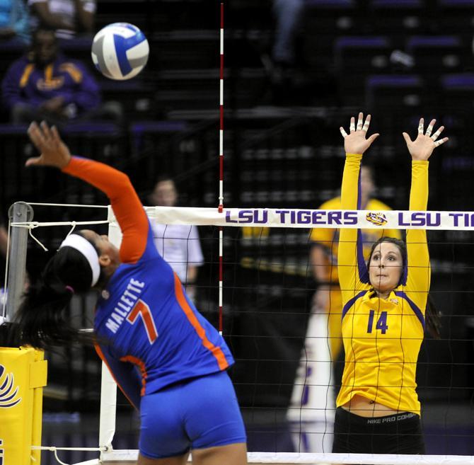 LSU junior setter Malorie Pardo (14) leaps to block Florida sophomore outside hitter Gabby Mallette (7) Friday, Nov. 1, 2013 during the Tiger's 3-1 loss to the Florida Gators in the PMAC.