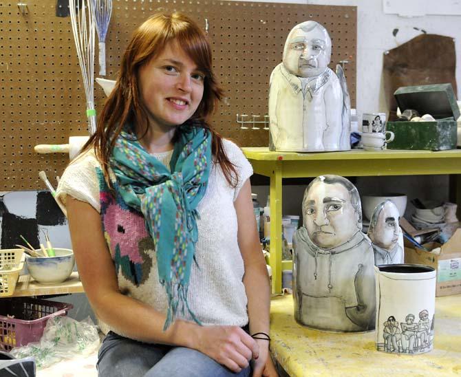 LSU ceramics grad student Autumn Higgins poses next to some of her original cermamic art on Tuesday, November 19, 2013, in her personal studio in the studio art building.