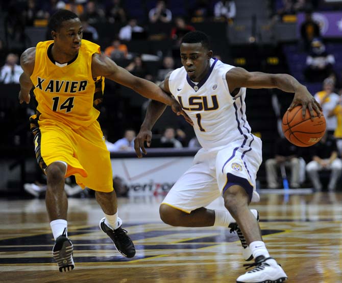 LSU junior gaurd Anthony Hickey (1) maneuvers the ball past Xavier sophomore guard Morris Wright (14) Wednesday, Nov. 6, 2013, during the Tigers' 80-45 victory at the Pete Maravich Assembly Center