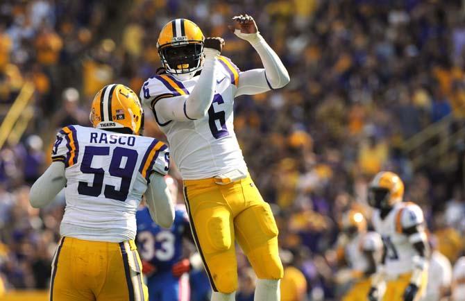 LSU senior safety Craig Loston (6) celebrates with teammate junior defensive end Jermauria Rasco (59) Saturday, Oct. 12, 2013 during the Tigers' 17-6 victory against Florida in Tiger Stadium.