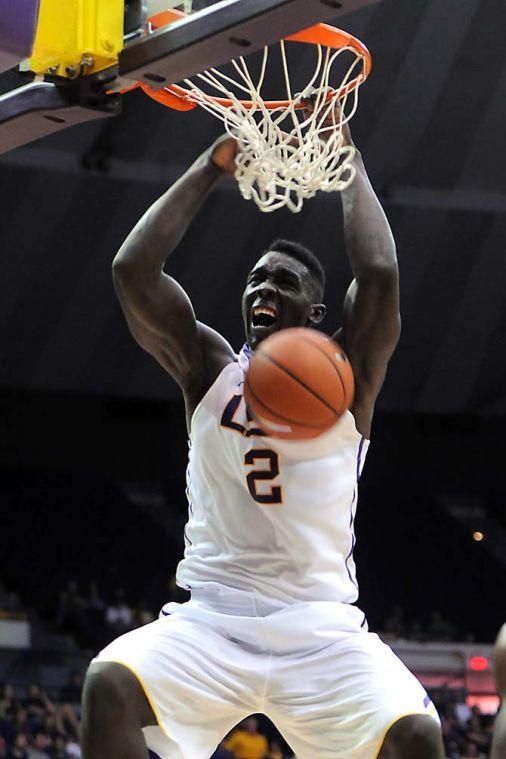 LSU junior forward Johnny O'Bryant III (2) hangs from the rim Saturday, Nov. 16, 2013 during the Tigers' 88-74 victory against Northwestern State in the PMAC.