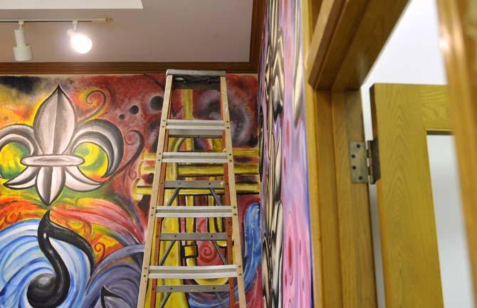 A ladder sits by the front entrance mural as artist Jiggy Johnson takes a break from painting on Tuesday, November 5, 2013, inside the building that will soon by Triumph Kitchen on 3rd Street downtown.