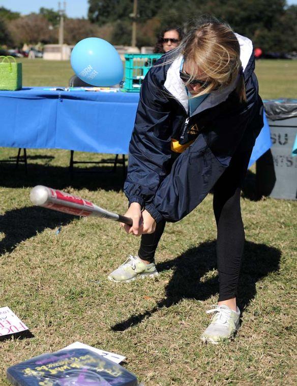 Communication disorders freshman Mary Kate McHugh swings at a scale Wednesday, November 13, 2013 at the Southern Smash event on the Parade Grounds.