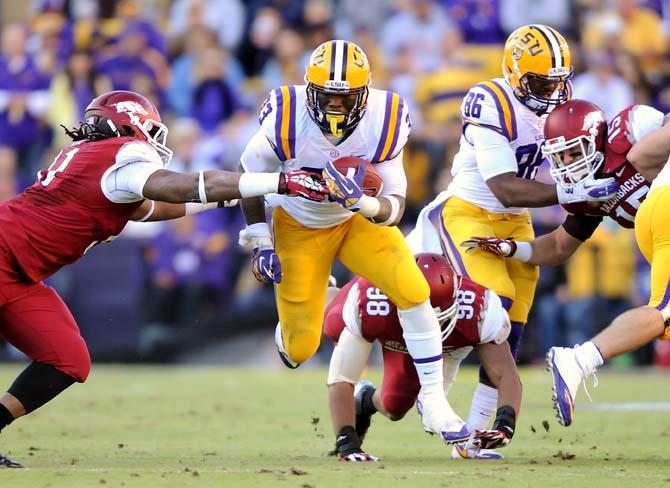 LSU sophomore running back Jeremy Hill (33) attempts to break the tackle of an oncoming Arkansas defender Friday, Nov. 29, 2013 during the Tigers' 31-27 victory against the Razorbacks in Tiger Stadium.