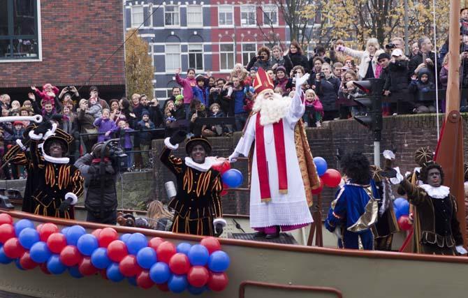 Sinterklaas and his Zwarte Pieten sail Sunday, Nov. 17, 2013, down Amstel River toward the center of Amsterdam in The Netherlands' version of a Saint Nicholas parade.