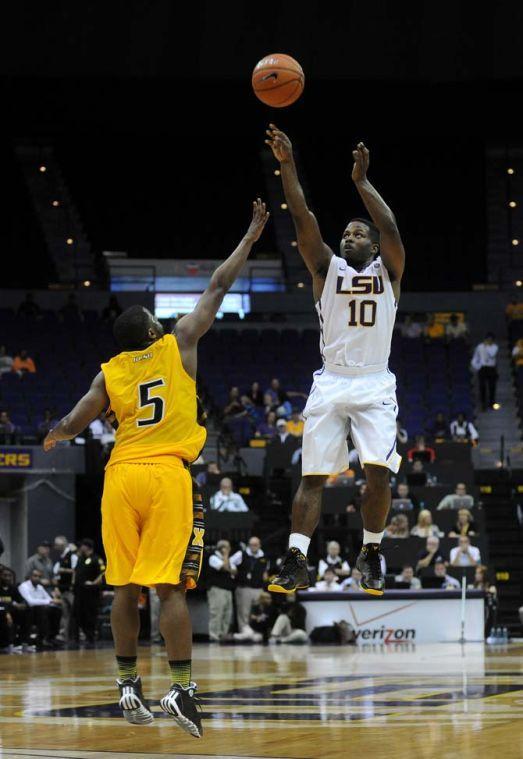 LSU senior gaurd Andre Stringer (10) propels the ball past Xavier sophomore guard Gary Smith (5) Wednesday, Nov. 6, 2013, during the Tigers' 80-45 victory at the Pete Maravich Assembly Center.