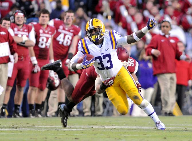 LSU sophomore running back Jeremy Hill (33) attempts to break the tackle of an oncoming Arkansas defender Friday, Nov. 29, 2013 during the Tigers' 31-27 victory against the Razorbacks in Tiger Stadium.