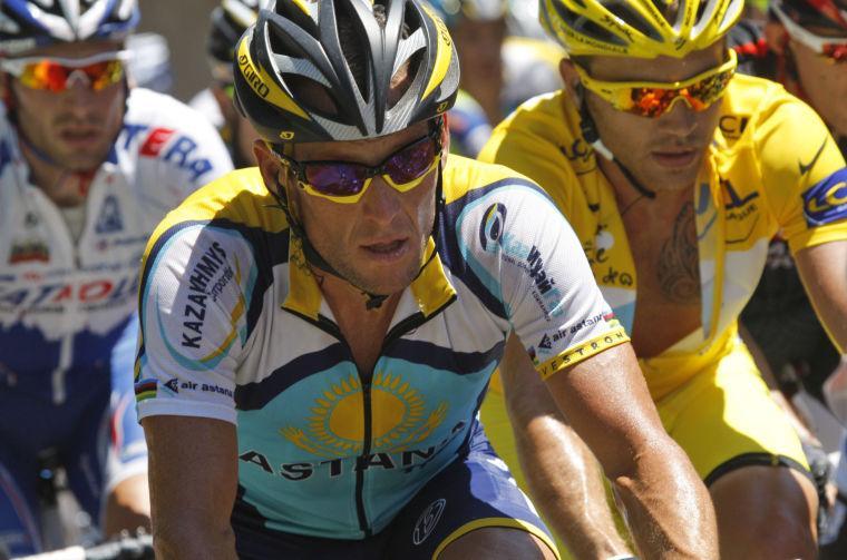 FILE - In this July 11, 2009 file photo, American seven-time Tour de France winner Lance Armstrong, left, and Rinaldo Nocentini of Italy, wearing the overall leader's yellow jersey, right, climb towards Col de Port , France, during the 8th stage of the Tour de France cycling race over 176.5 kilometers (109.7 miles) with start in Andorra and finish in Saint-Girons, France. When Alex Gibney set out to document the cyclist Armstrong&#8217;s 2009 Tour de France comeback, the filmmaker admits he bought into the hype: The man who&#8217;d cheated death was coming back to reign supreme -- clean. Gibney's documentary, "The Armstrong Lie, " from Sony Pictures Classics releases Friday, Nov. 8, 2013. (AP Photo/Christophe Ena)