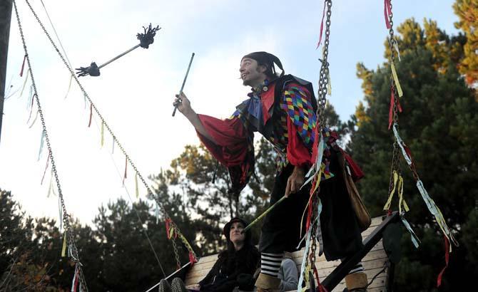 A juggler stands on a swing Sunday, Nov. 24, 2013 at the Louisiana Renaissance Festival in Hammond, La.