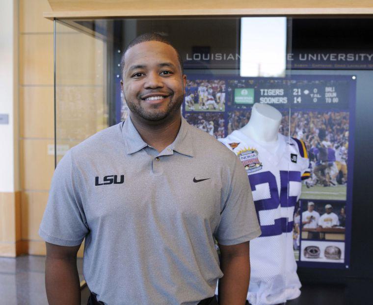 Former LSU running back Jusin Vincent stands next to his old jersey Monday, Nov. 19, 2013 in the Football Operations Building.