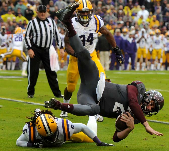 LSU senior safety Craig Loston (6) tackles Texas A&amp;M quarterback Johnny Manziel (2) on Saturday, Nov. 20, 2013 during the Tiger's 34-10 victory against the Aggies.