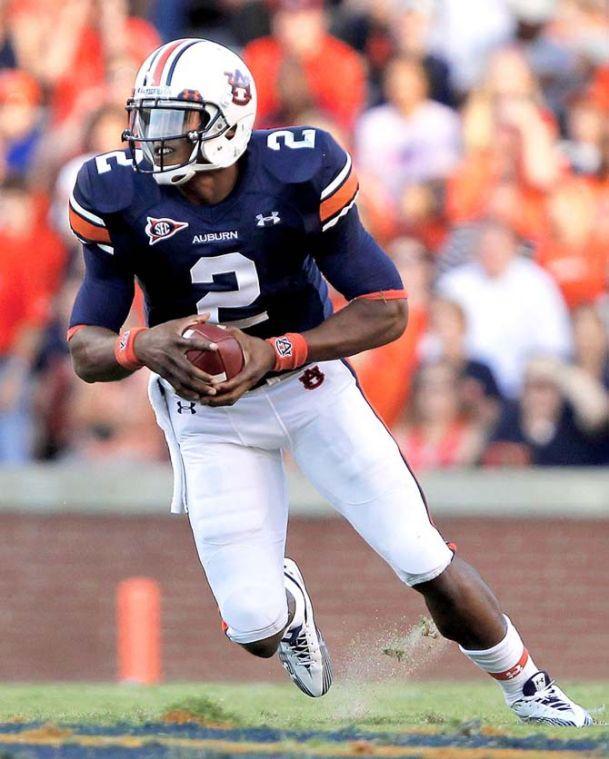 FILE - In this Sept. 4, 2010, file photo, Auburn quarterback Cameron Newton (2) runs for a first down against Arkansas State during an NCAA college football game in Auburn, Ala. While the Carolina Panthers remain mum, few others are about what they should do next week with the No. 1 pick. There's little consensus among the draft pundits, however, with the most polarizing opinions Newton. (AP Photo/ Butch Dill, File)