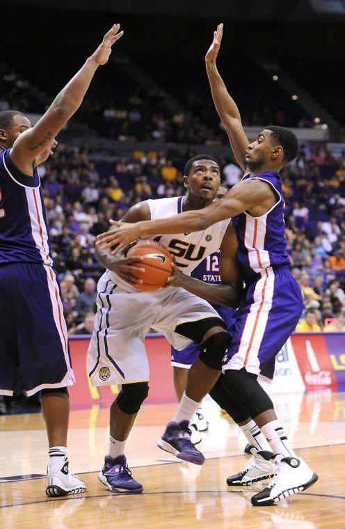 LSU freshman forward Jordan Mickey (25) wards off multiple Northwestern State defenders Saturday, Nov. 16, 2013 during the Tigers' 88-74 victory against the Demons in the PMAC.