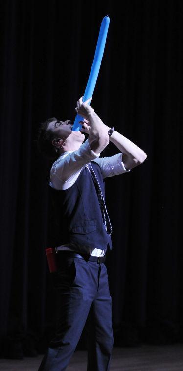 Adam Trent swallows a ballon Wednesday, Nov. 13, 2013 during his Magic Show in the Union Theater.