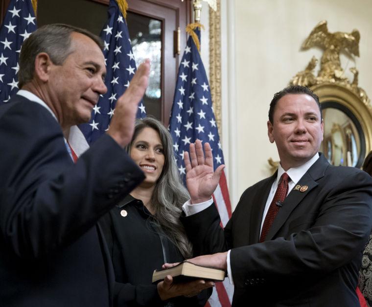 House Speaker John Boehner of Ohio, left, holds a ceremonial swearing-in for newly-elected Rep. Vance McAllister, R-La., Thursday, Nov. 21, 2013, on Capitol Hill in Washington. McAllister&#8217;s wife Kelly, watches at center. (AP Photo/J. Scott Applewhite)