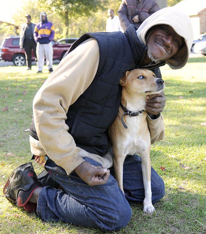 Cornelius and his dog Peaches attend the Kitchens on the Geaux breakfast Sunday morning Nov. 24, 2013 at Expressway Park.