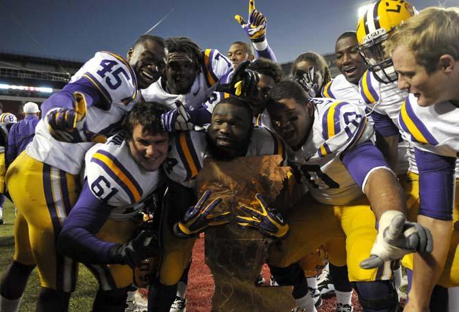 Members of the LSU football team pose around "The Boot" trophy after the Tigers 20-13 win over the Razorbacks on November 23, 2012 in Fayetteville.