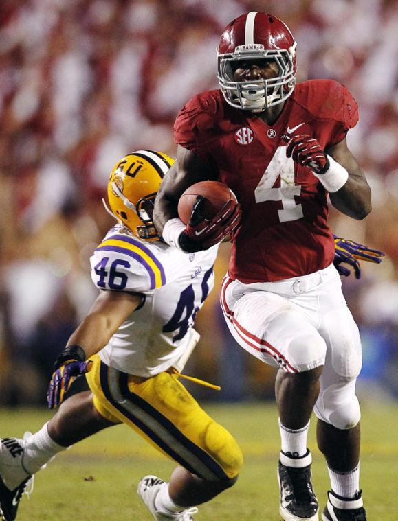 Alabama running back T.J. Yeldon (4) eludes LSU linebacker Kevin Minter (46) for the winning touchdown in the second half of their NCAA college football game in Baton Rouge, La., Saturday, Nov. 3, 2012. Alabama won 21-17. (AP Photo/Gerald Herbert)