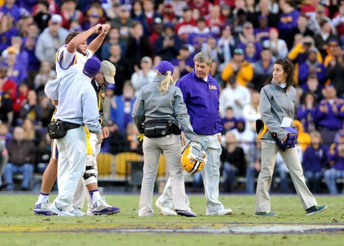 LSU senior quarterback Zach Mettenberger (8) raises his hands triumphantly after being injured Friday, Nov. 29, 2013 during the Tigers' 31-27 victory against Arkansas in Tiger Stadium.