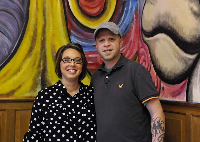 Owners Chris and Sommer Wadsworth stand in front of one of the partially finished murals in their kitchen school on Tuesday, November 5, 2013 in the building that will soon be Triumph Kitchen on 3rd Street downtown.