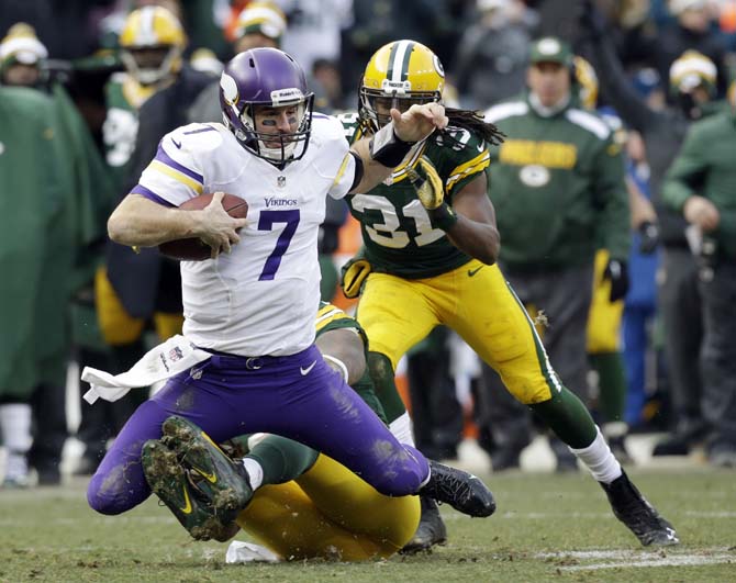 Minnesota Vikings quarterback Christian Ponder (7) is sacked by Green Bay Packers' Mike Neal during the second half of an NFL football game Sunday, Nov. 24, 2013, in Green Bay, Wis. The game ended in a tie, 26-26. (AP Photo/Jeffrey Phelps)