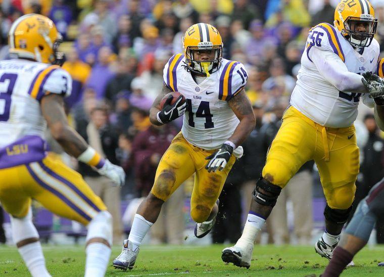 LSU junior running back Terrence Magee (14) carries the ball downfield Saturday Nov. 23, 2013 during the Tigers' 34-10 victory against Texas A&amp;M in Tiger Stadium.