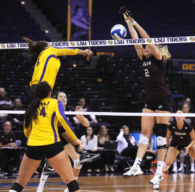 Texas A&amp;M sophomore middle blocker Sullivan (2) kills one past LSU senior middle blocker Desiree Elliott (4) Wednesday, Nov.13, 2013 during the Tigers' loss to the Aggies.