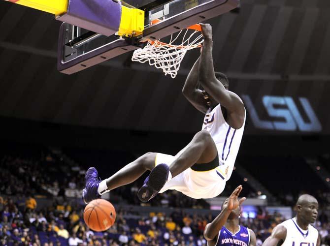 LSU junior forward Johnny O'Bryant III (2) hangs from the rim Saturday, Nov. 16, 2013 during the Tigers' 88-74 victory against Northwestern State in the PMAC.