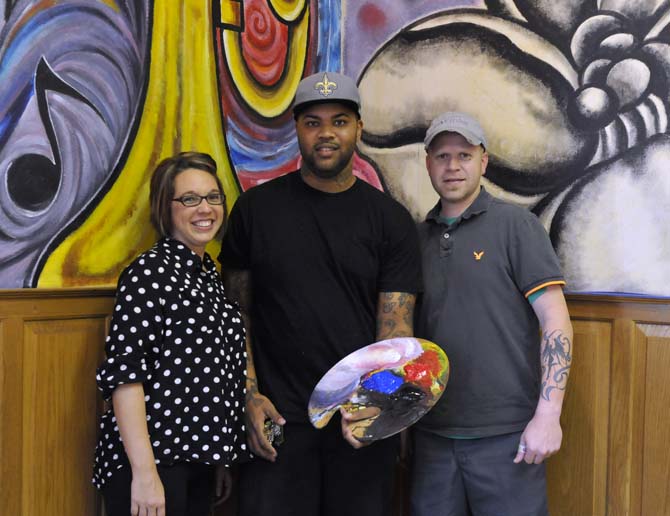 Owners Chris and Sommer Wadsworth stand with the artist who will be painting murals on almost every wall in their cooking school, Jiggy Johnson, on Tuesday, November 5, 2013 in the building that will soon be Triumph Kitchen on 3rd Street downtown.