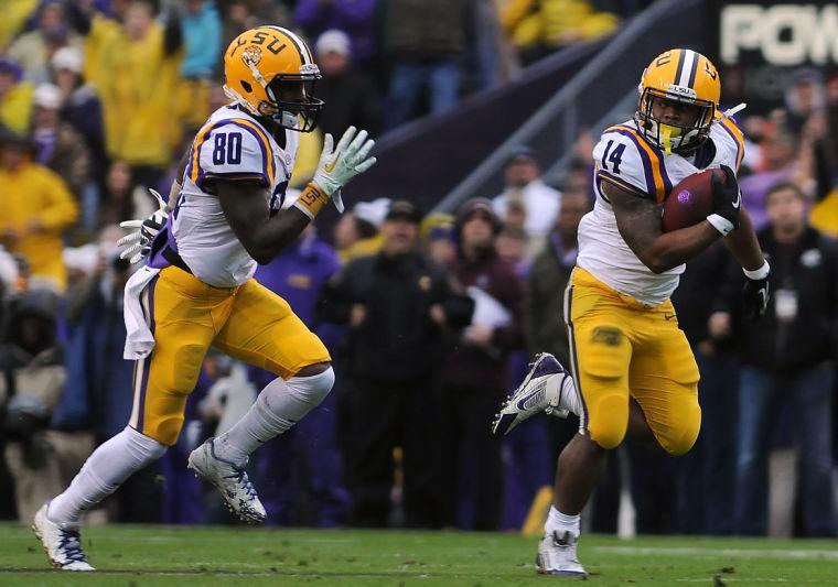 LSU junior running back Terrence Magee (14) carries the ball downfield as LSU junior wide receiver Jarvis Landry (80) runs alongside him Saturday Nov. 23, 2013 during the Tigers' 34-10 victory against Texas A&amp;M in Tiger Stadium.