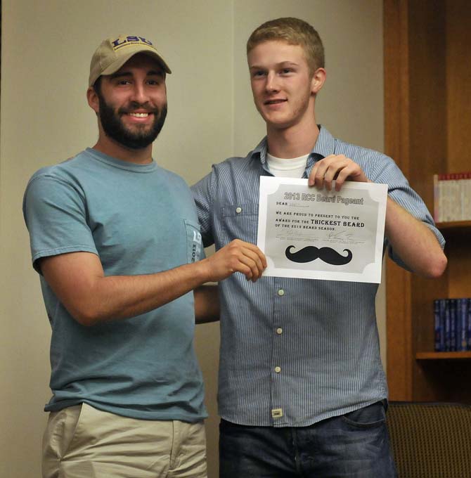 Accounting major Matthew Ledet accepts his award as "Thickest Beard" Tuesday, December 3, 2013, at the South Hall Residential College.