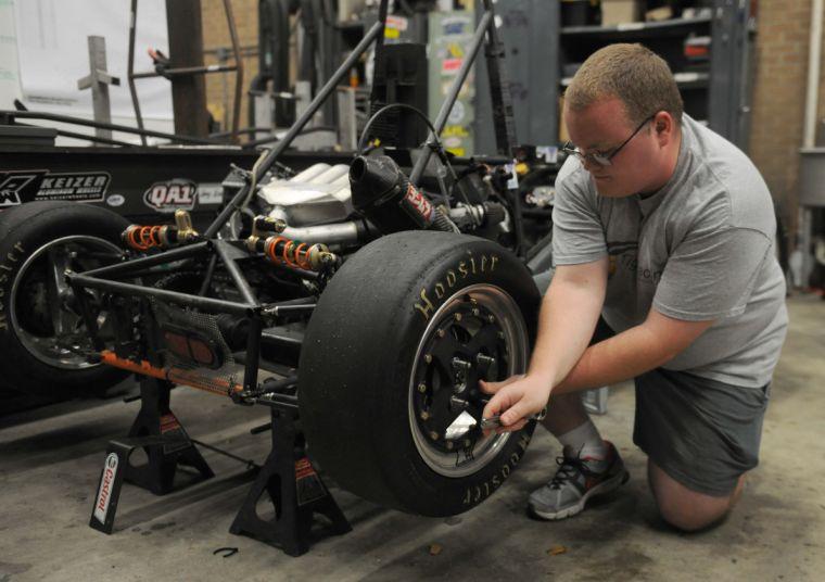 Mechanical engineering sophomore Eric Rohli changes the tire on the Team Tiger Racing car Wednesday, Dec. 4, 2013 in the LSU Mechanical Engineering Shop.