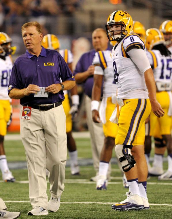 LSU offensive coordinator Cam Cameron and senior quarterback Zach Mettenberger (8) watch a warm up play Aug. 31, 2013 before the 37-27 victory against TCU in the Cowboys Classic at AT&amp;T Stadium in Arlington, Texas.