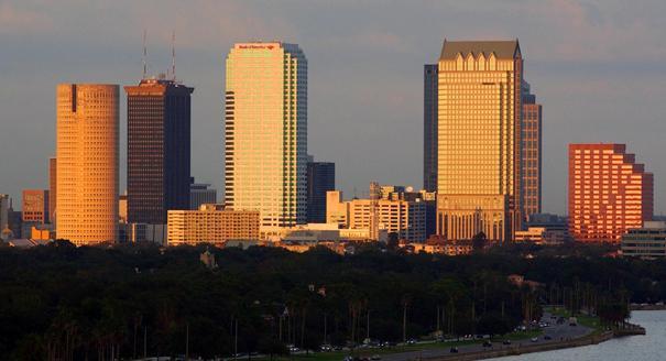 The light from a setting sun illuminates the Tampa skyline.