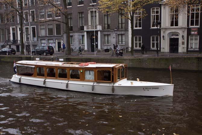 A boat drives down a canal in Amsterdam's city center. The study abroad experience can lead to adventure and uncertainty.