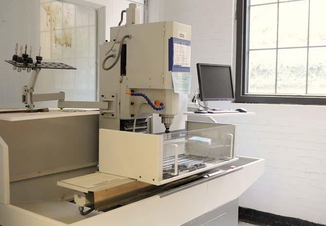 One of the machines used to create designs and textures sits in the woodshop on Tuesday, Dec. 3, 2013, in the wood shop inside the design building.