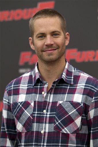 FILE - In this April 29, 2011 file photo, actor Paul Walker poses during the photo call of the movie " Fast and Furious 5," in Rome. Walker was drawing parallels before his untimely death between his real-life role as dad to 14-year-old daughter Meadow and his part as an unexpected father to a newborn baby in the upcoming Hurricane Katrina drama "Hours." Walker said in a Nov. 14, 2013 interview with The Associated Press to promote the new film releasing on Dec. 13, 2013, that he was still finding his way as a father. (AP Photo/Andrew Medichini, File)