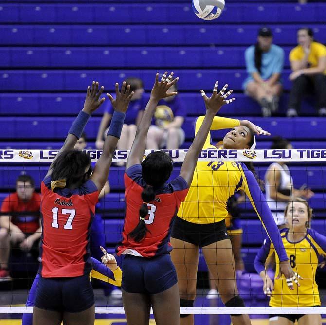 LSU freshman middle blocker Briana Holman (13) leaps up to spike the ball Friday, October 11, 2013 during the Tigers' victory against Ole Miss in the PMAC.