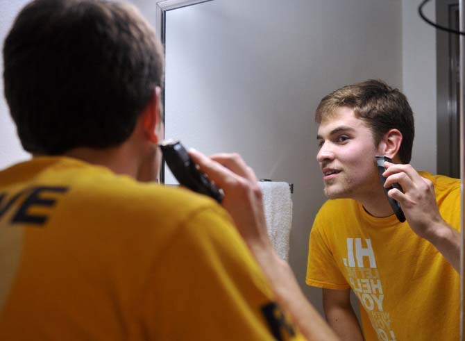 Petroleum Engineering Kurt Vardeman shaves his beard into a wild design for the No Shave November contest Tuesday, December 3, 2013, at the South Hall Residential College.